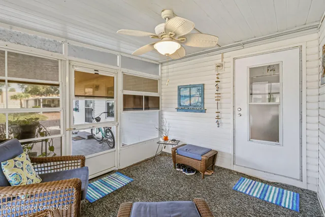 a living room with furniture a rug and a chandelier