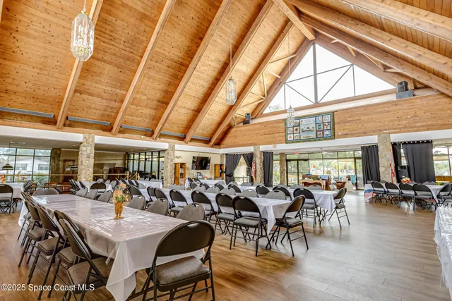 a view of a dining hall with lots of furniture and wooden floor