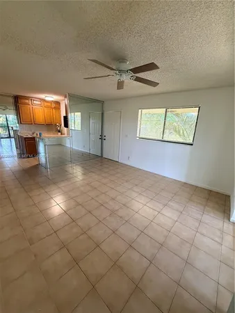an empty room with projector and fan