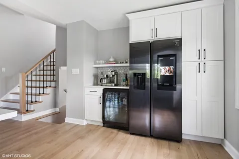 a kitchen with kitchen island granite countertop stainless steel appliances and a refrigerator