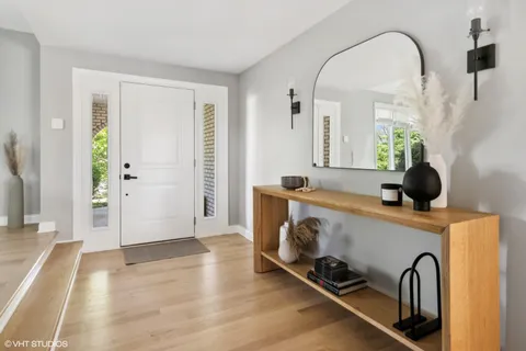 a view of an entryway with wooden floor