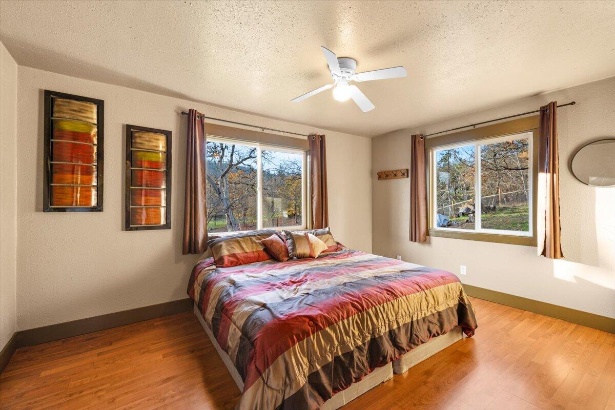 1360 Oxyoke Road Grants Pass, OR 97526 - Photo 27 of 39 a bed sitting in a bedroom next to a window