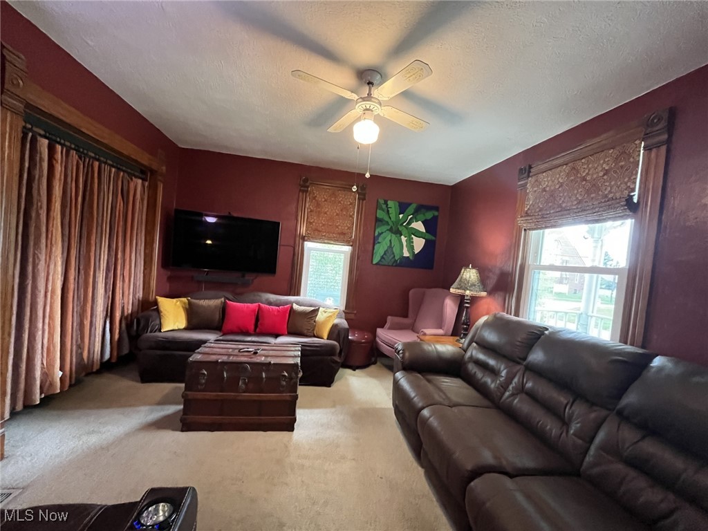 2710 7th Street Northwest Canton, OH 44708 - Photo 13 of 17 Living room featuring carpet, ceiling fan, and a textured ceiling