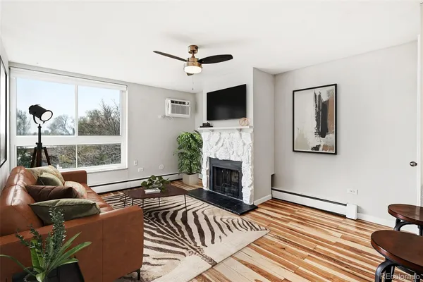 a living room with furniture a flat screen tv and a fireplace