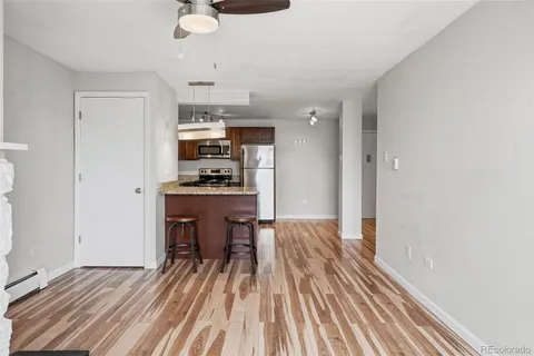 a view of kitchen with sink microwave and refrigerator