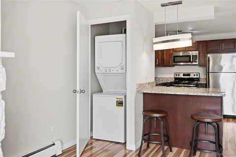 a kitchen with stainless steel appliances a refrigerator and microwave