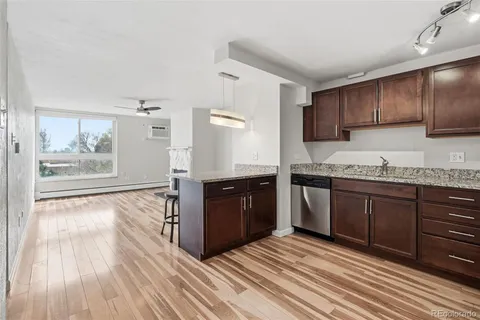 a large kitchen with wooden floors and wooden cabinets