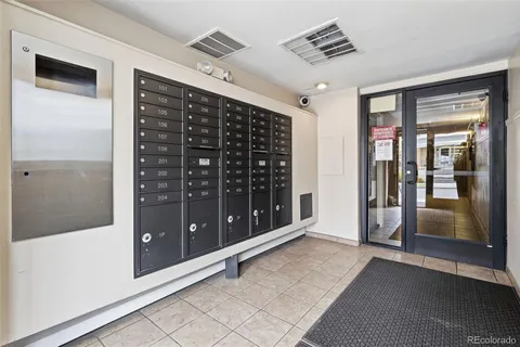 a view of a hallway with wooden shelves