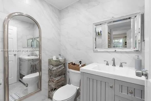 a bathroom with a sink a toilet and mirror