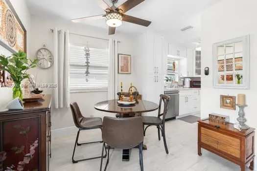 a dining room with furniture and window