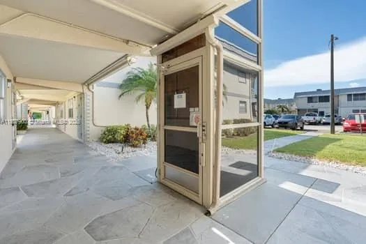 a view of a porch with a floor to ceiling window and yard