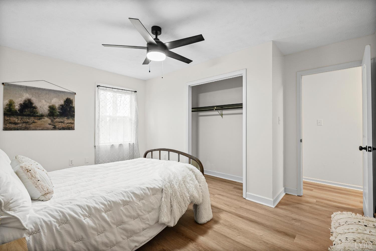 2622 Bethany Road Rustburg, VA 24588 - Photo 12 of 28 a bedroom with a bed and wooden floor