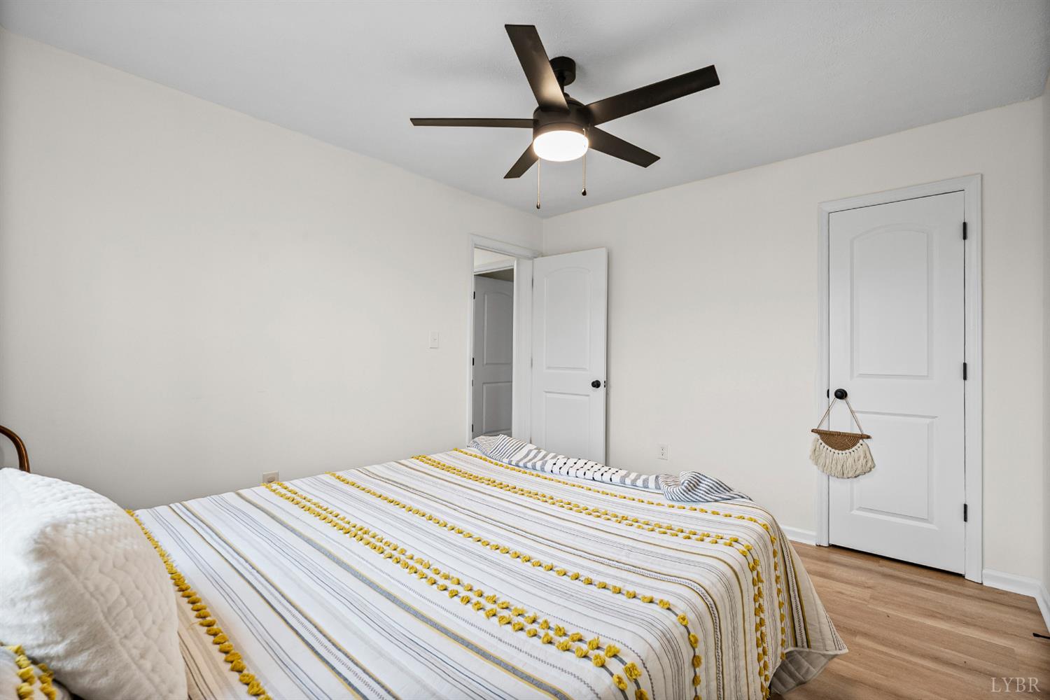 2622 Bethany Road Rustburg, VA 24588 - Photo 15 of 28 a bedroom with a large bed and a chandelier