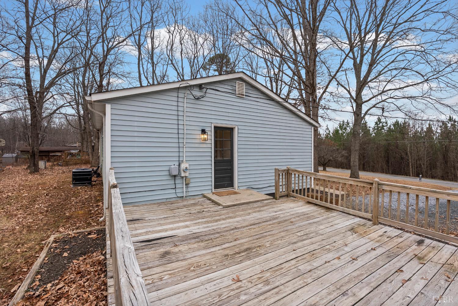 2622 Bethany Road Rustburg, VA 24588 - Photo 19 of 28 a backyard of a house with wooden fence and large trees