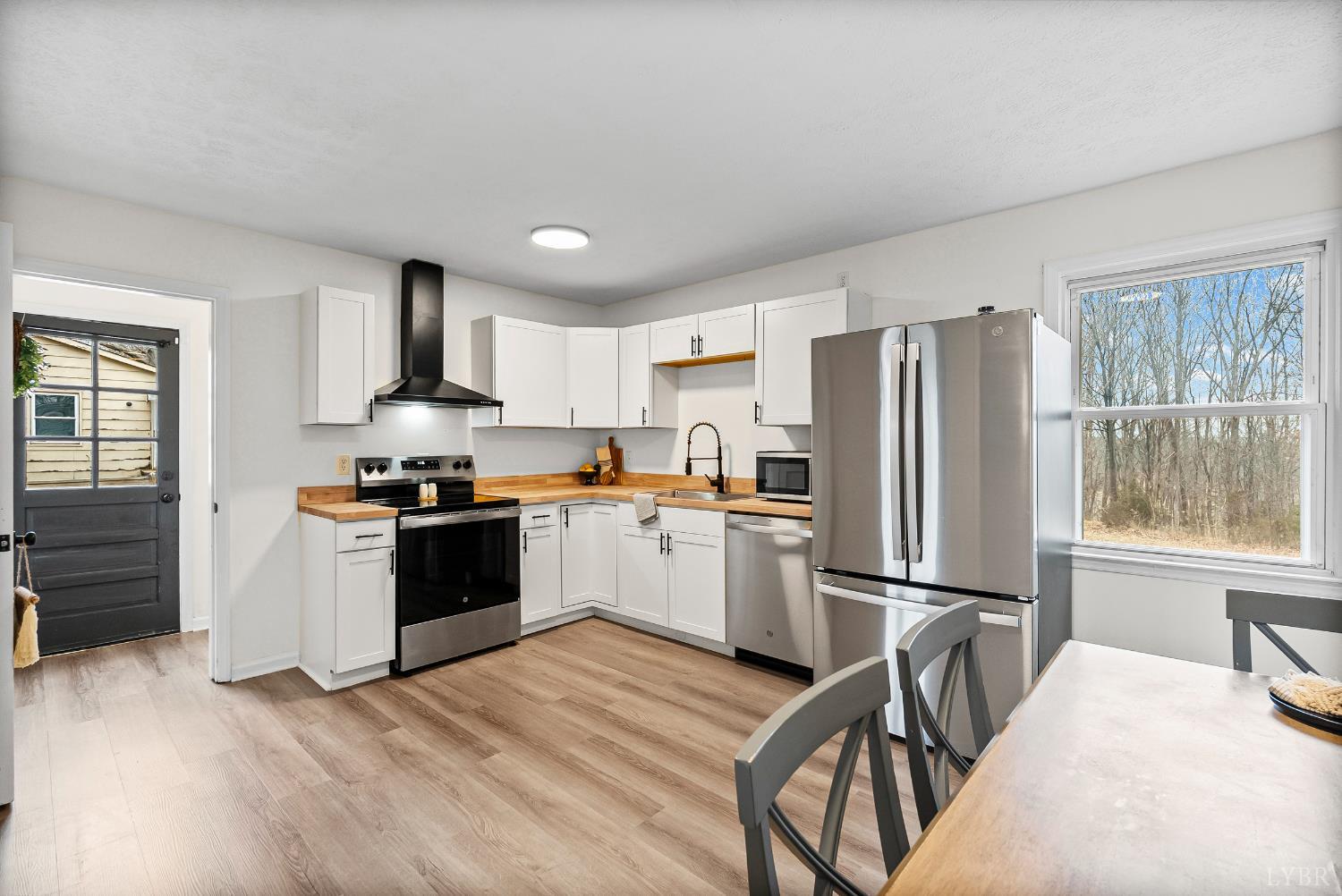 2622 Bethany Road Rustburg, VA 24588 - Photo 5 of 28 a kitchen with granite countertop a refrigerator stove top oven and sink