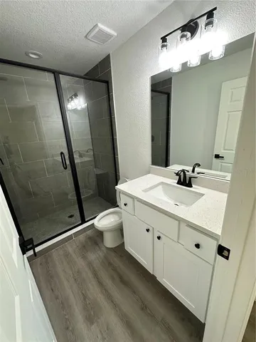 a bathroom with a double vanity sink mirror and toilet