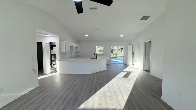 a large kitchen with a lot of counter space and stainless steel appliances