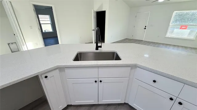 a kitchen with a sink and cabinets