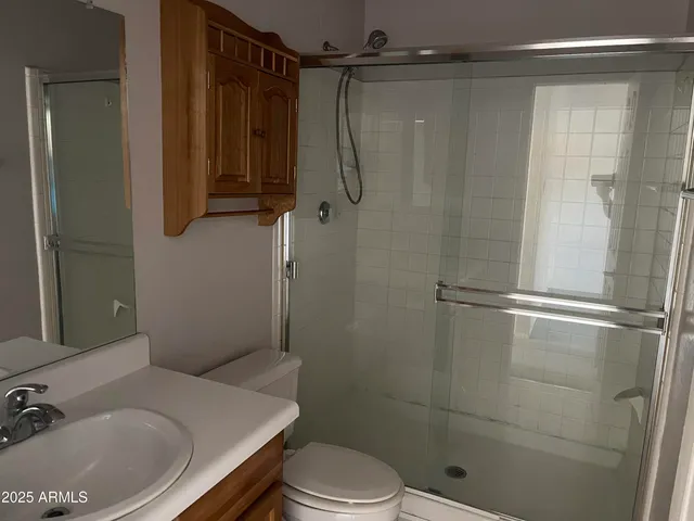 a bathroom with a shower and a toilet