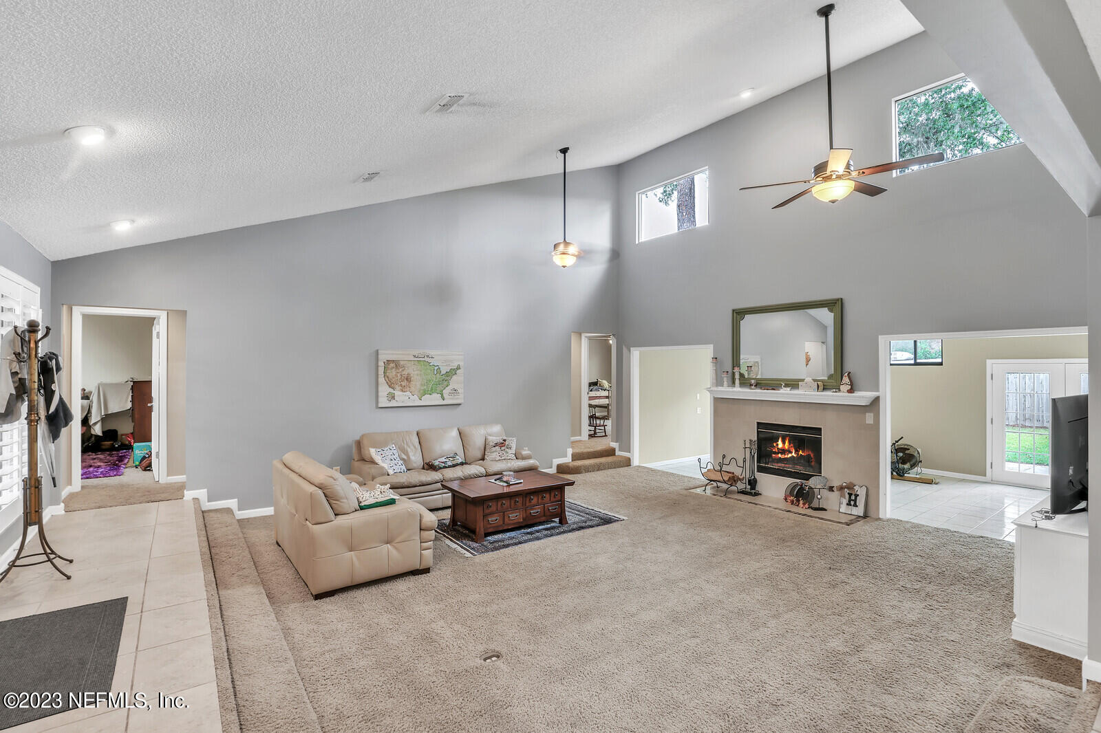 3001 Nautilus Road Middleburg, FL 32068 - Photo 14 of 26 a living room with furniture a fireplace and a chandelier
