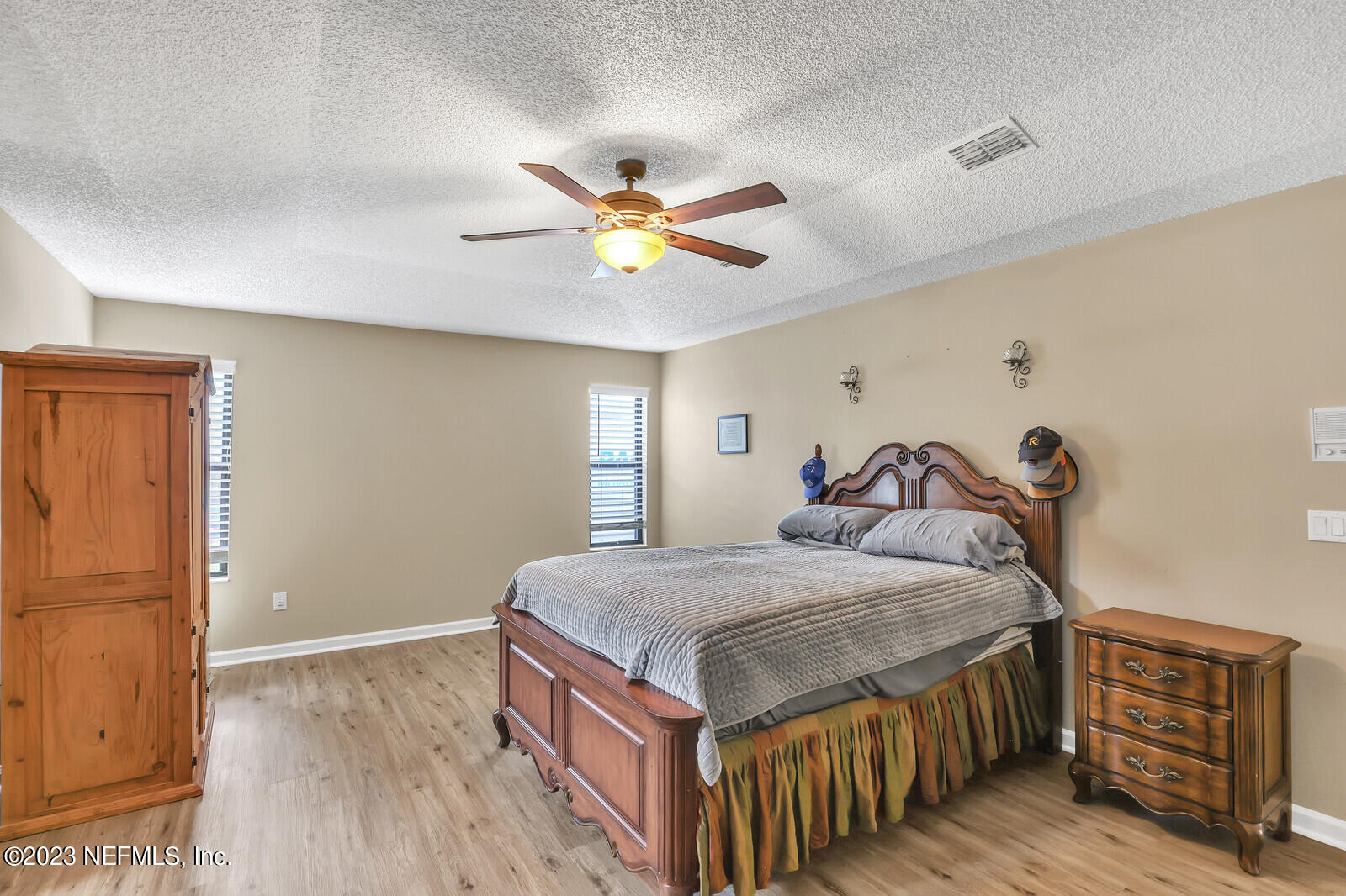 3001 Nautilus Road Middleburg, FL 32068 - Photo 19 of 26 a bedroom with a bed and a chandelier