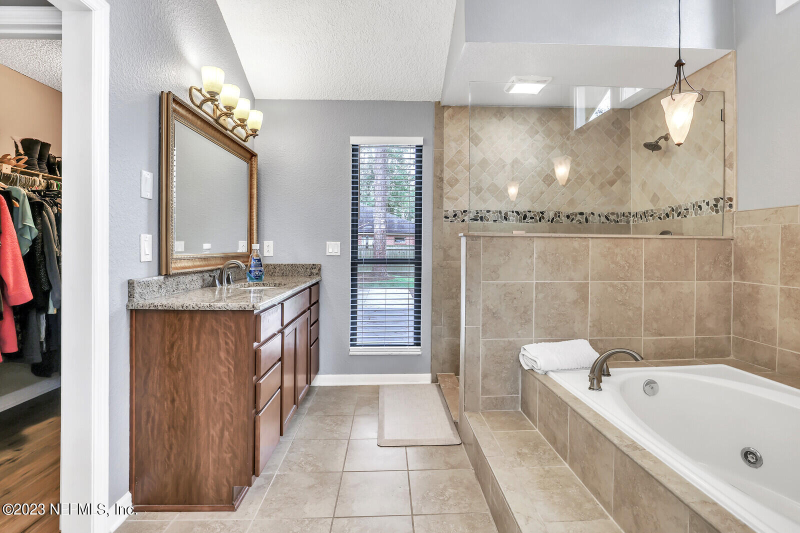 3001 Nautilus Road Middleburg, FL 32068 - Photo 22 of 26 a bathroom with a tub a sink and a mirror