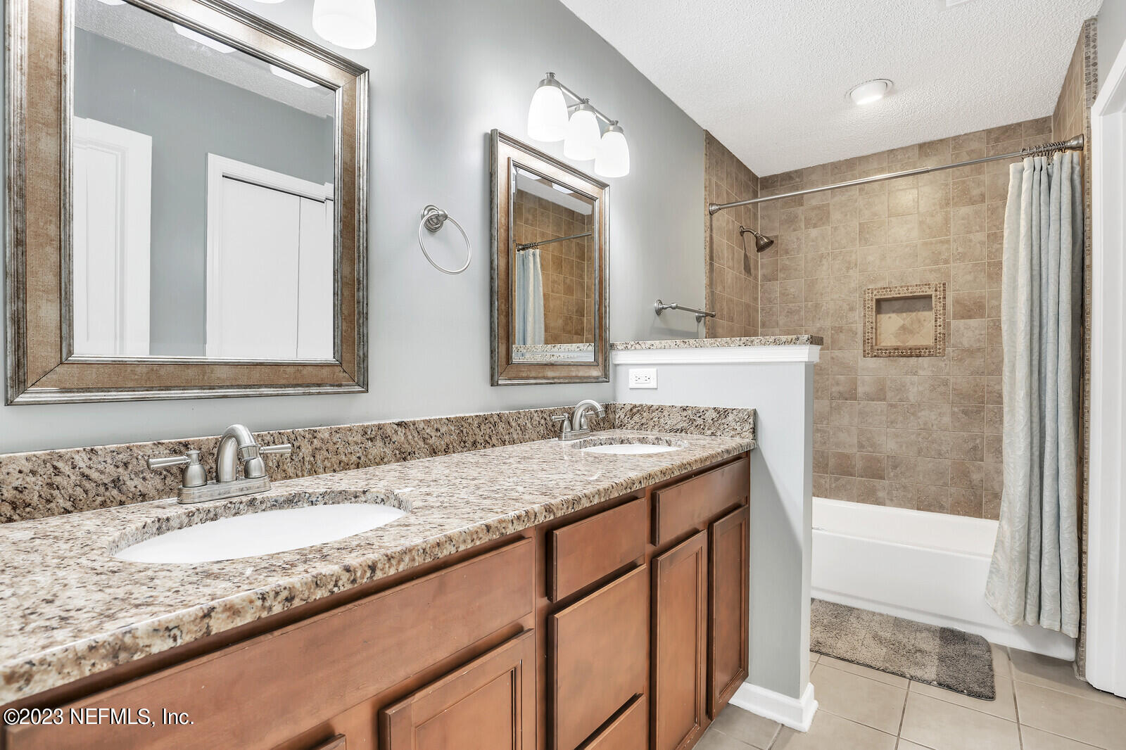3001 Nautilus Road Middleburg, FL 32068 - Photo 24 of 26 a bathroom with a granite countertop sink mirror and a