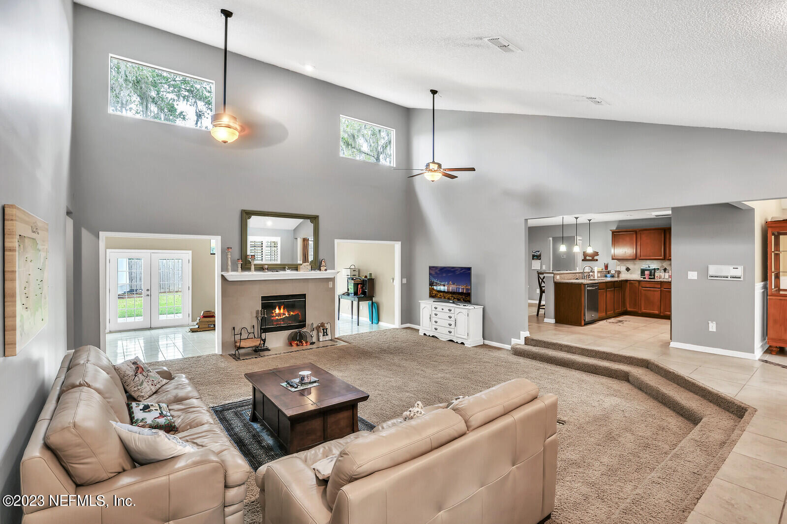 3001 Nautilus Road Middleburg, FL 32068 - Photo 10 of 26 a living room with furniture a fireplace and a flat screen tv