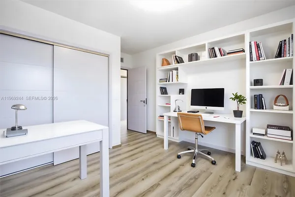 a view of a workspace with furniture and a flat screen tv