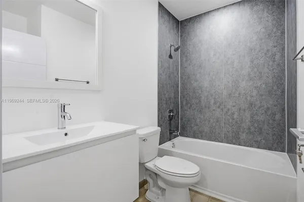 a bathroom with a sink a toilet and bathtub