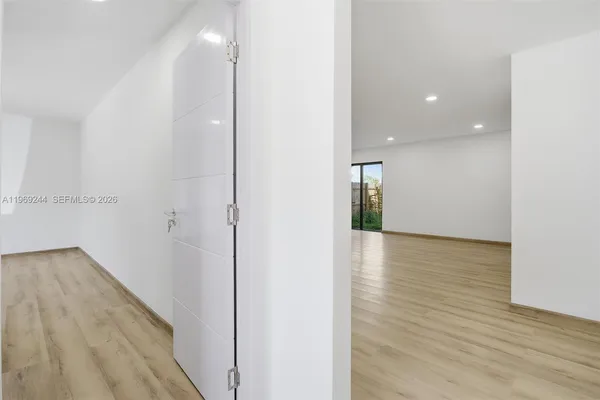 a view of hallway with wooden floor