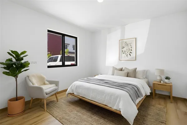 a bedroom with a bed and a potted plant