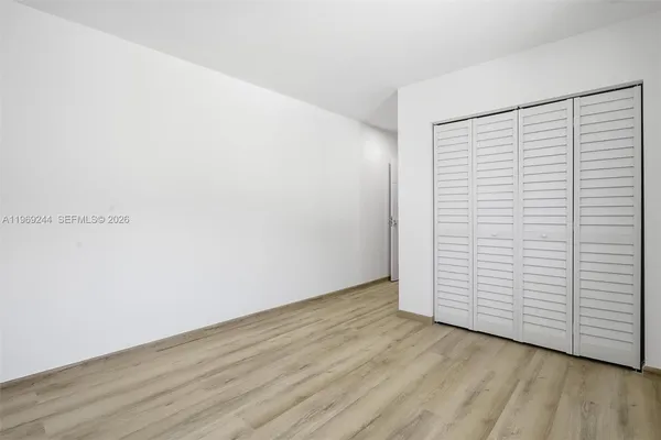 an empty room with wooden floor