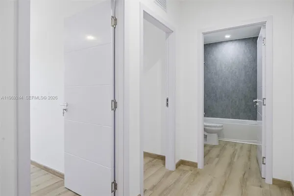 a view of a bathroom from a hallway