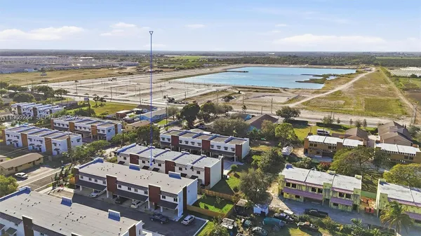 an aerial view of residential building and ocean
