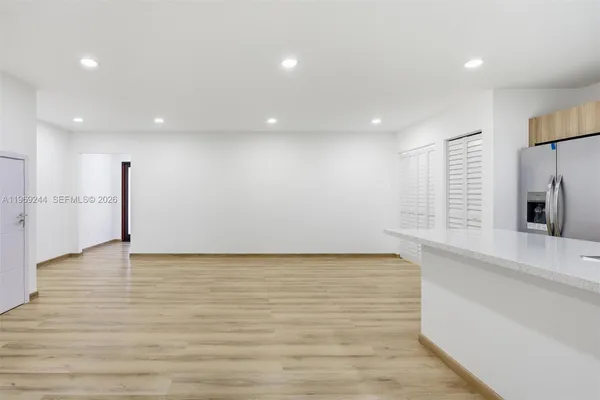 a view of a kitchen with a sink and a large window