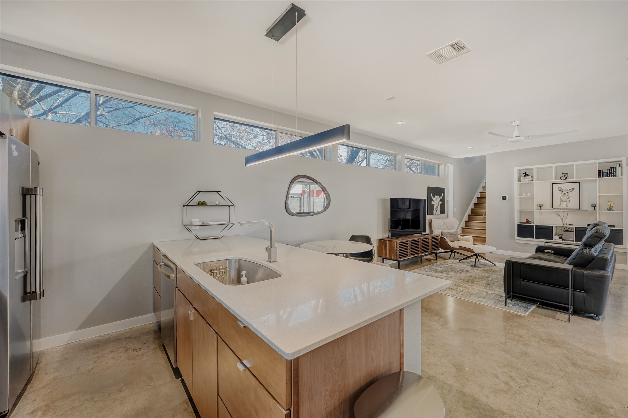 5909 Lux Street Austin, TX 78721 - Photo 28 of 28 Kitchen featuring stainless steel appliances, pendant lighting, Quartz countertops, and open floor plan