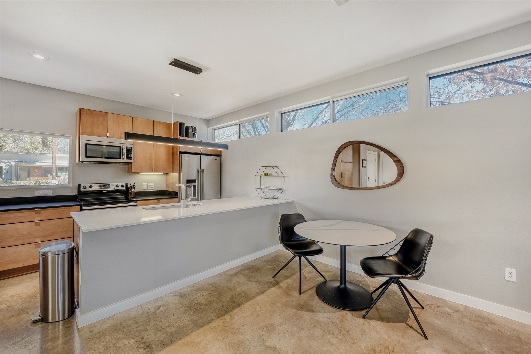 5909 Lux Street Austin, TX 78721 - Photo 13 of 28 Dining area with a peninsula, modern cabinets, and concrete flooring