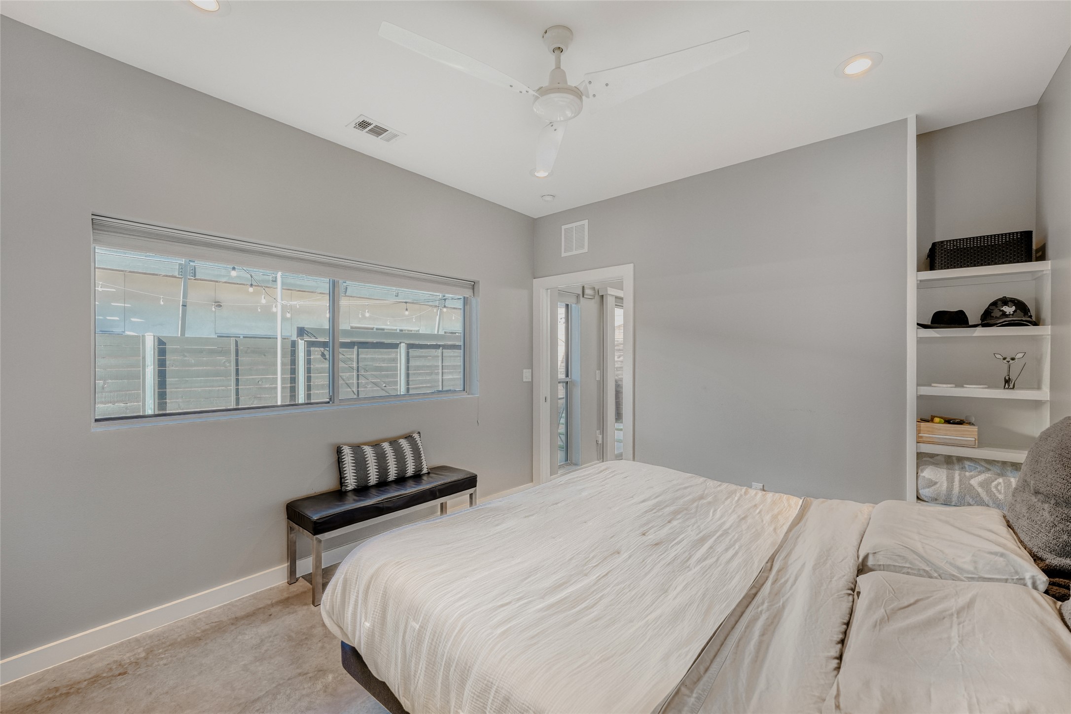5909 Lux Street Austin, TX 78721 - Photo 15 of 28 Primary bedroom with a ceiling fan, built in shelves and recessed lighting