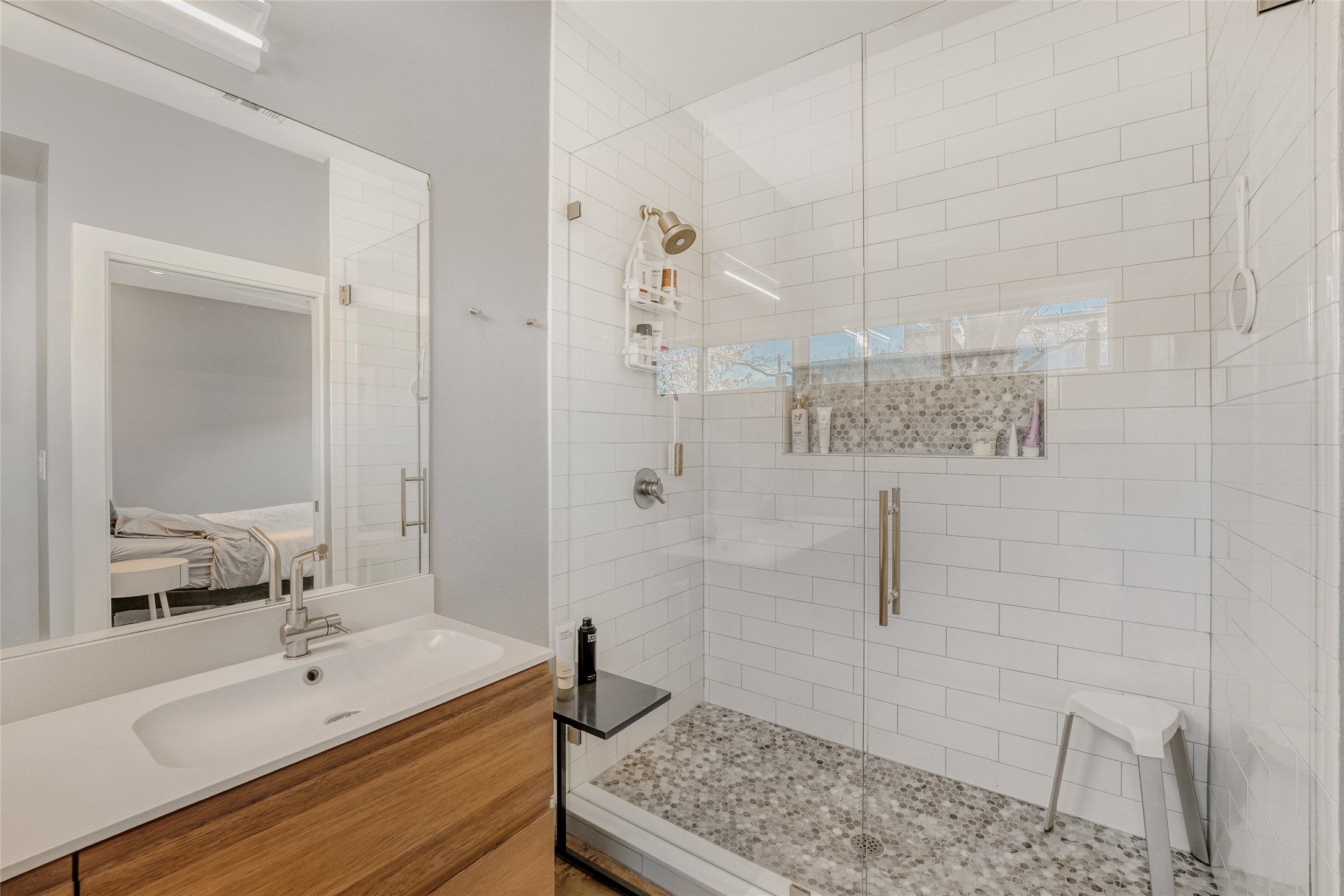 5909 Lux Street Austin, TX 78721 - Photo 16 of 28 Ensuite bathroom featuring dual vanity and walk-in shower with tile floors