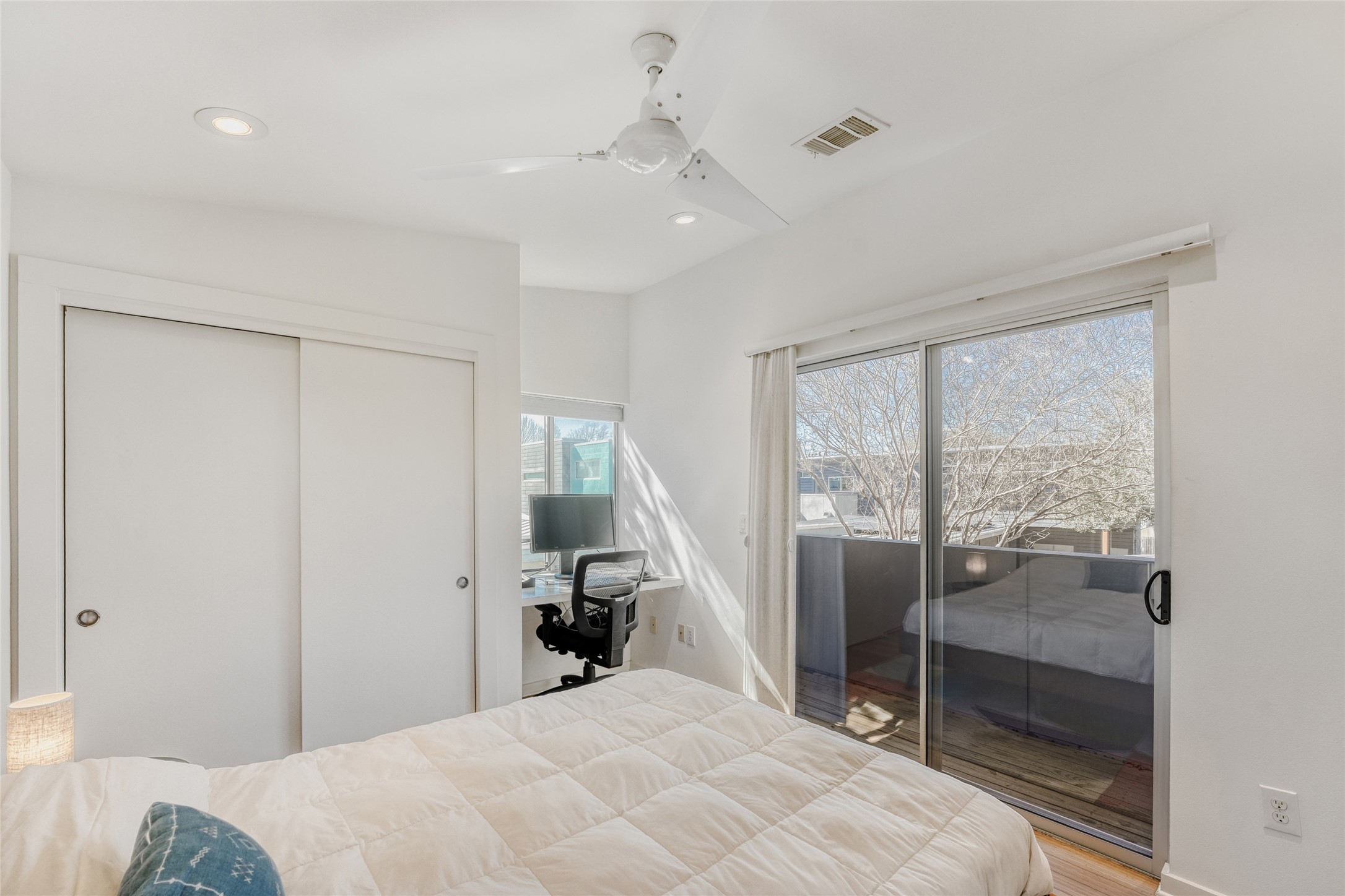 5909 Lux Street Austin, TX 78721 - Photo 20 of 28 Bedroom #2 with a desk, a closet, ceiling fan, recessed lighting, and access to exterior balcony terrace
