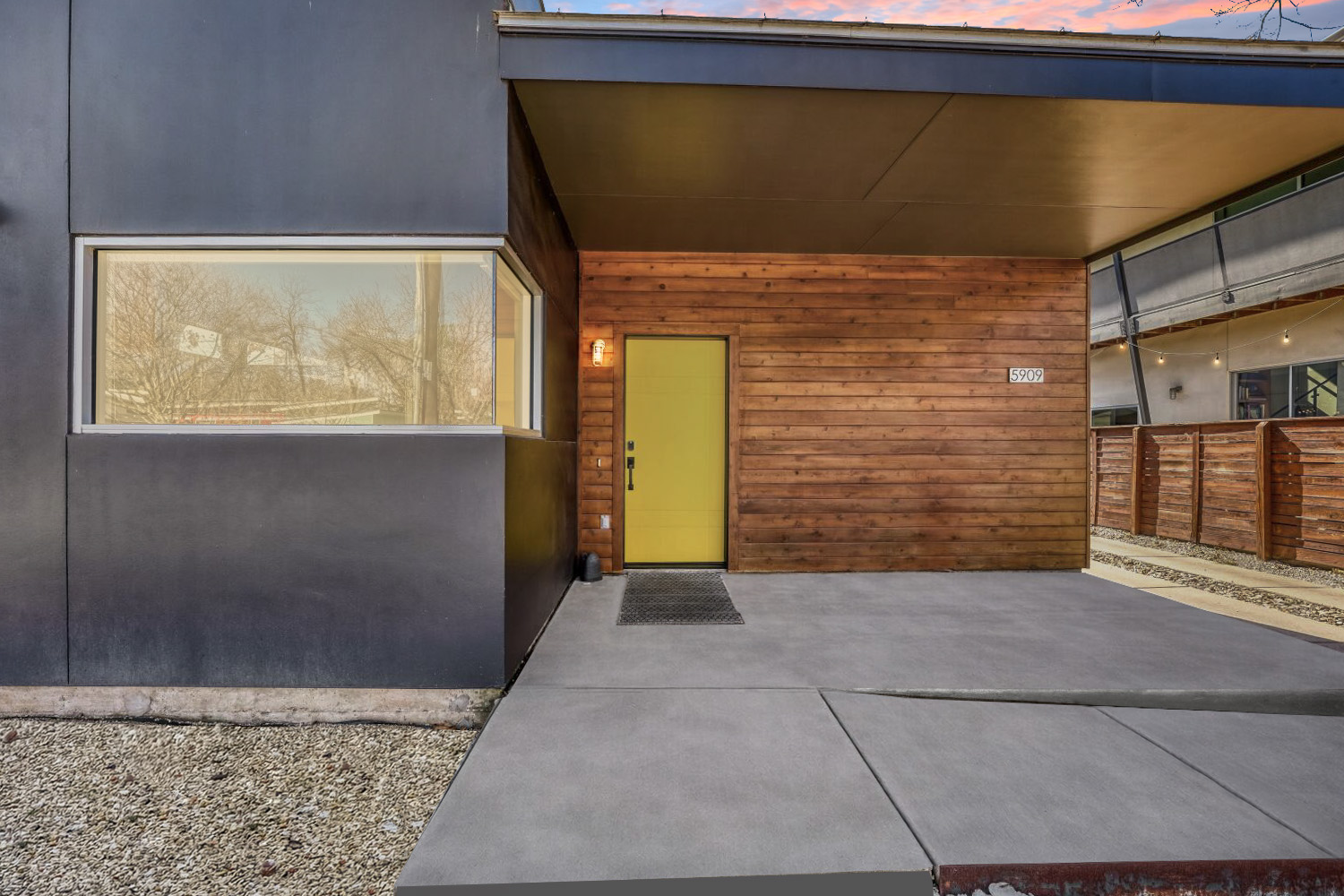 5909 Lux Street Austin, TX 78721 - Photo 26 of 28 Entrance to property with concrete ramp, stucco, large windows & attractive cedar