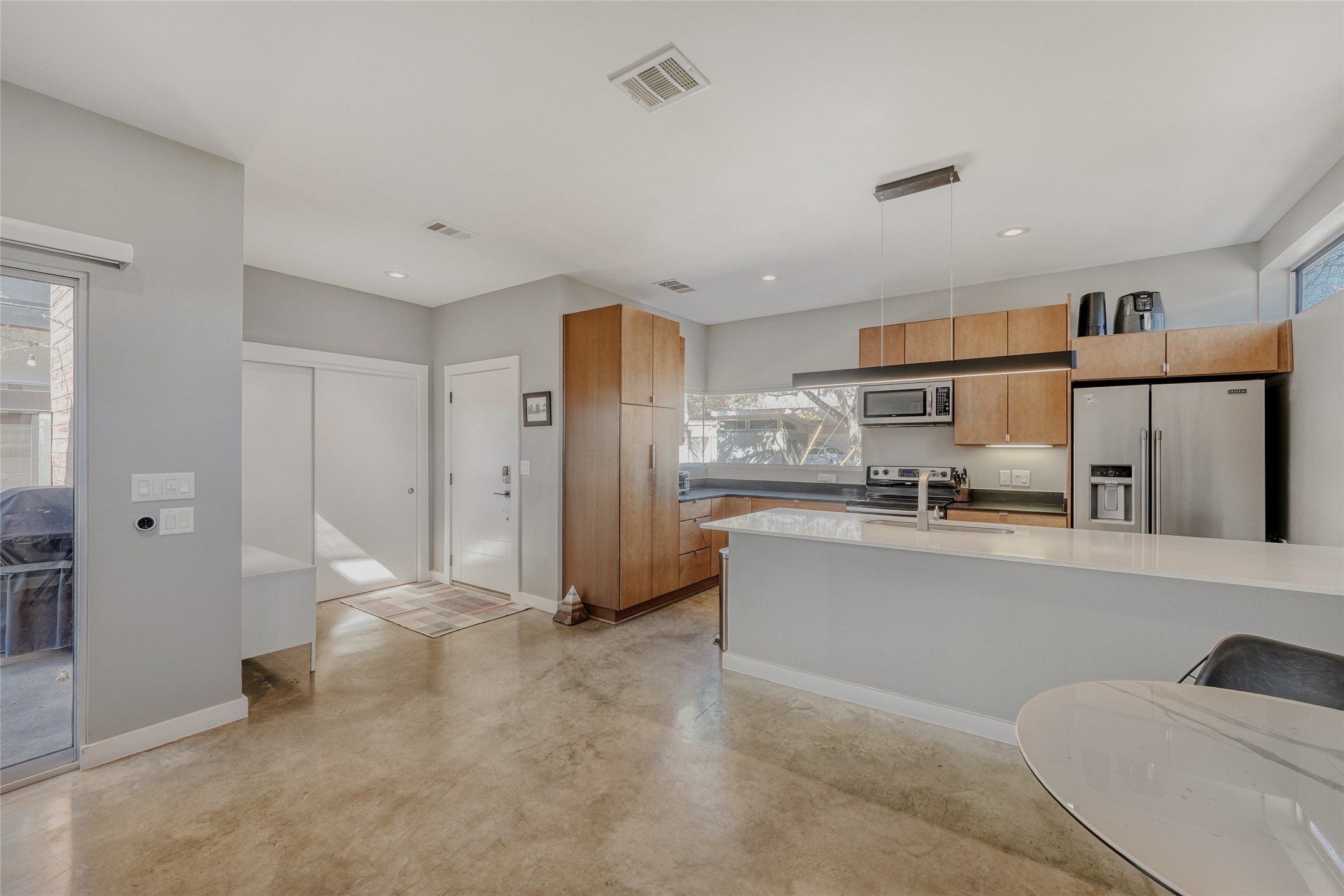 5909 Lux Street Austin, TX 78721 - Photo 10 of 28 Kitchen with stainless steel appliances, hanging light fixtures, modern cabinets, healthy amount of natural light, and recessed lighting