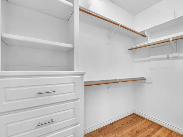 a view of walk in closet with empty racks