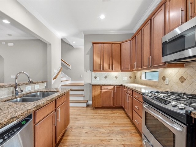 2505 Dallas Street Houston, TX 77003 - Photo 4 of 13 a kitchen with granite countertop stainless steel appliances and wooden cabinets