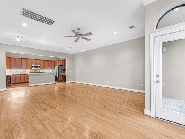 2505 Dallas Street Houston, TX 77003 - Photo 5 of 13 a view of an empty room with a kitchen and wooden floor