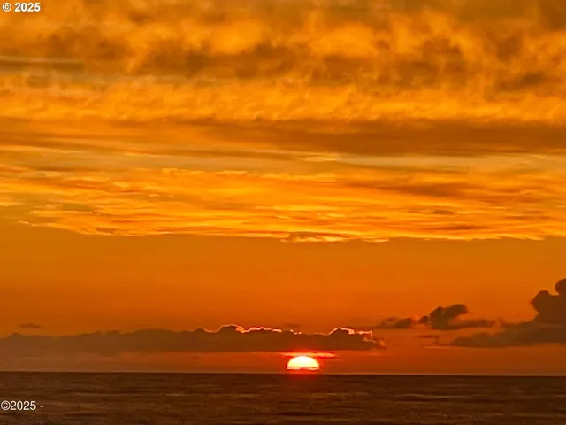 a view of ocean with sunset