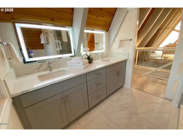 a bathroom with a double vanity sink and mirror