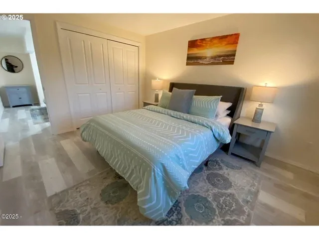 a bedroom with a bed and a mirror