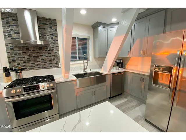 a kitchen with a sink and stainless steel appliances